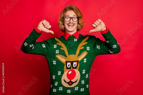 Photo of shiny excited young man wear green sweater spectacles smiling pointing thumbs himself isolated red color background