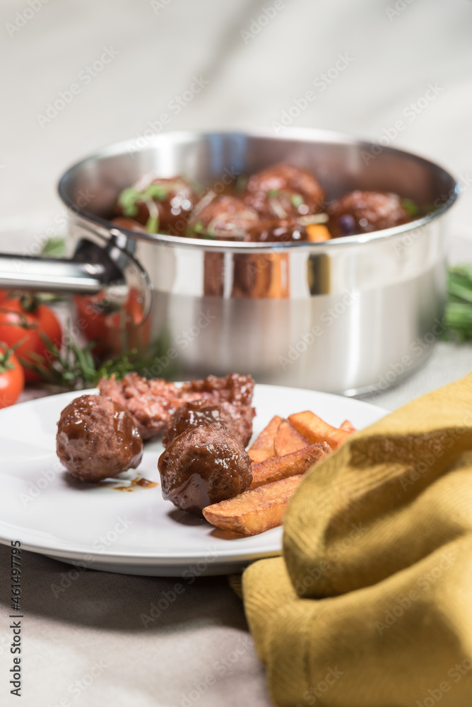 Stewed meatballs in cheese sauce