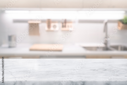 Selective focus,Marble table top on blur white kitchen room background.