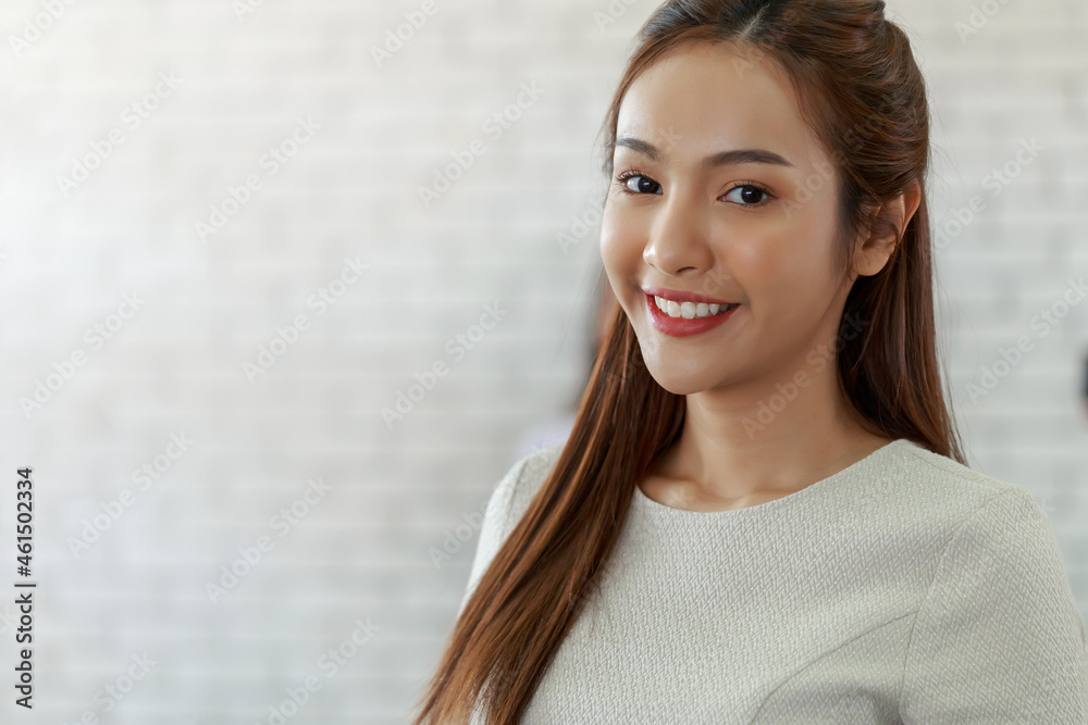 Young beautiful secretary Asian woman standing in the office with smiley face Young beautiful secretary Asian woman standing in the office with smiley face