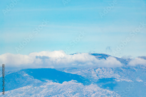 Clouds over the top of the mountains seen from the city of Madrid, in Spain. Europe. Horizontal photography.
