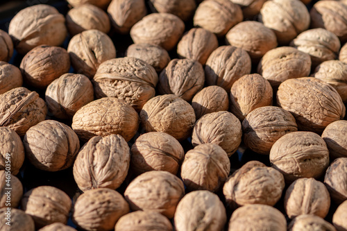 A bunch of walnuts, selective focus, general plan, top view.Concept: source of protein and vitamins, sale of nuts on the market.
