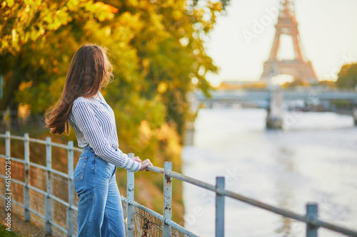 Beautiful young woman enjoying bright autumn day in Paris, France