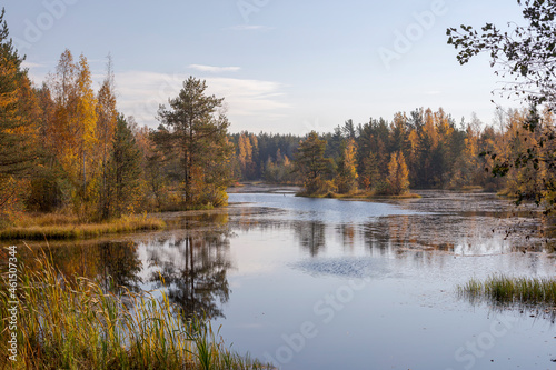 Beautiful lake in a forest in autumn. Trees that change color in autumn.