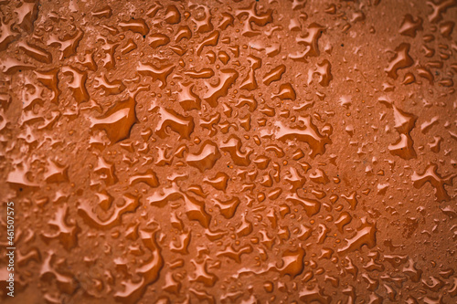 Water drops and splashes on brown color leather material, table top view