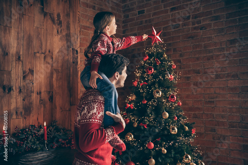 Photo of positive daughter father family put star christmas tree tradition good mood inside house home flat