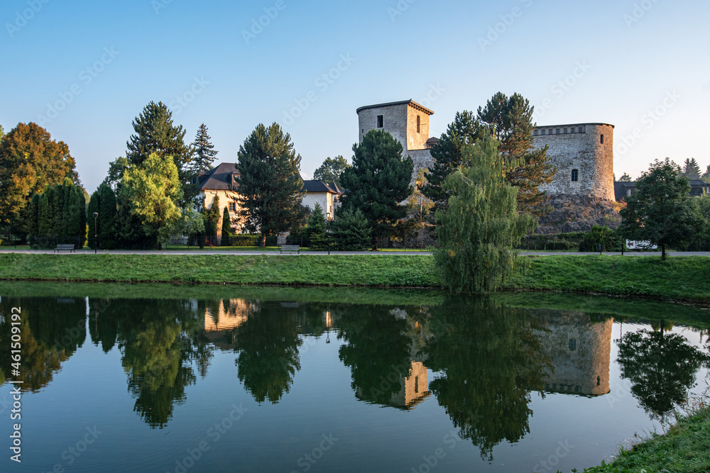 View of the castle and its reflection on the surface of the lake and in Liptovský Hrádok, a small town in Slovakia at sunrise. View of the castle and its reflection on the surface of the lake and in Liptovský Hrádok, a small town in Slovakia at sunrise.