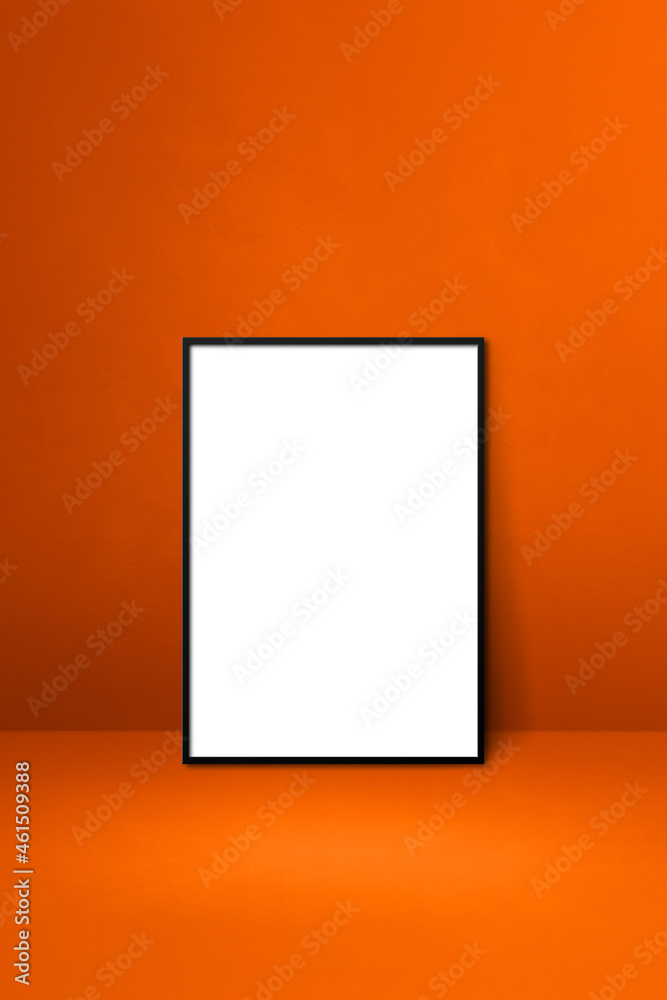Black picture frame leaning on an orange wall Black picture frame leaning on an orange wall