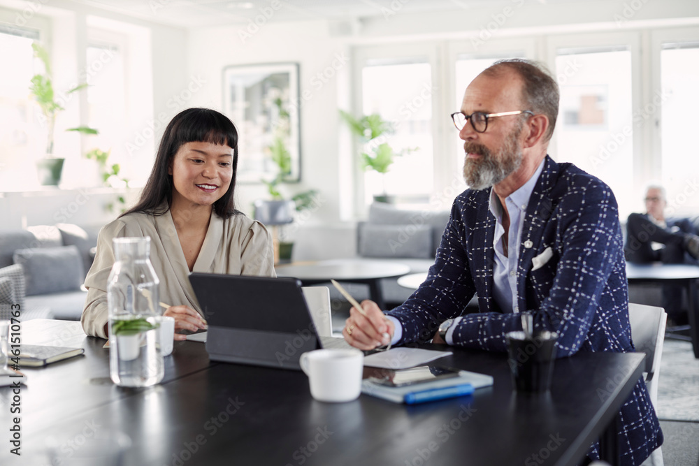 Coworkers talking in office Coworkers talking in office