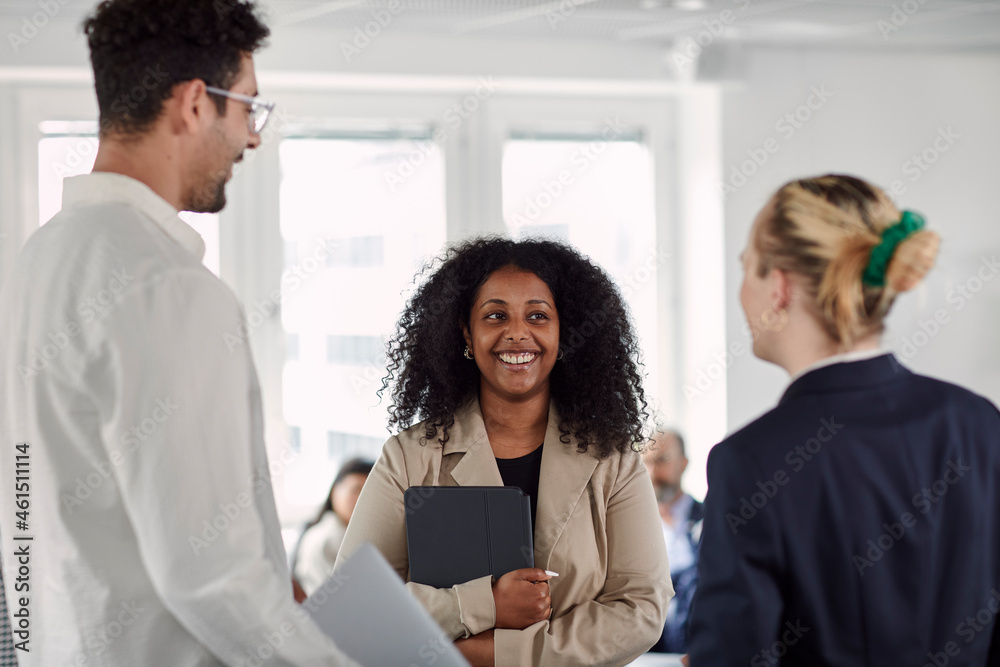 Coworkers talking in office