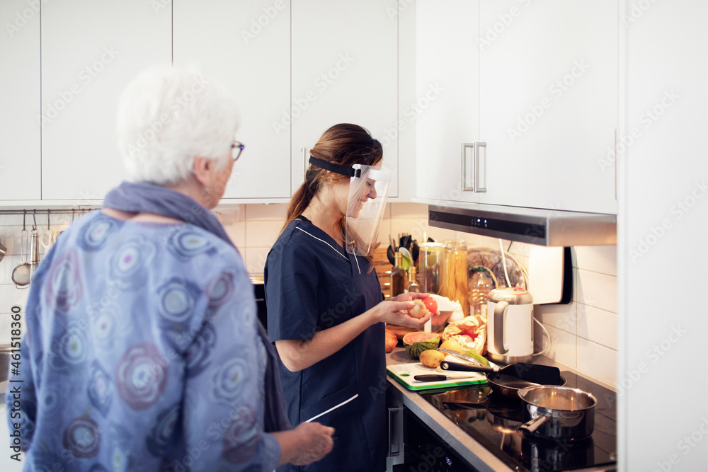 Nurse helping elderly woman at home Nurse helping elderly woman at home
