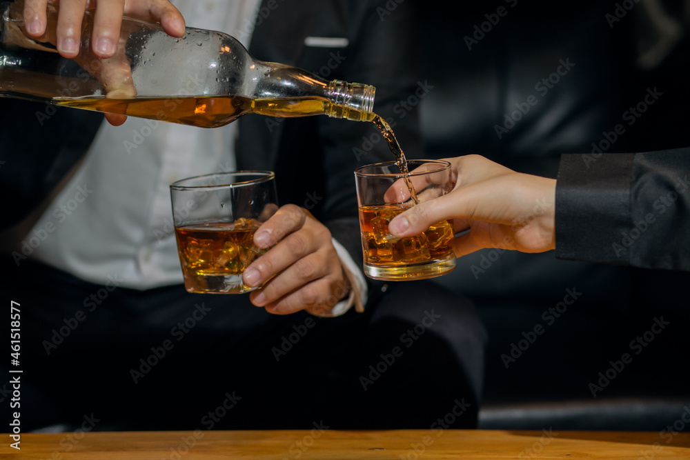Businessmen in suits drinking whiskey Businessmen in suits drinking whiskey