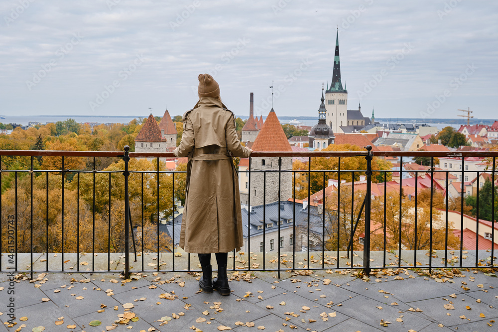 Obraz na płótnie Blonde woman enjoy panorama of the city of Tallinn. Amazing scenic view of the old town. Girl explore Estonia, Europe. City and sea. City autumn landscape, old historical architecture. w salonie