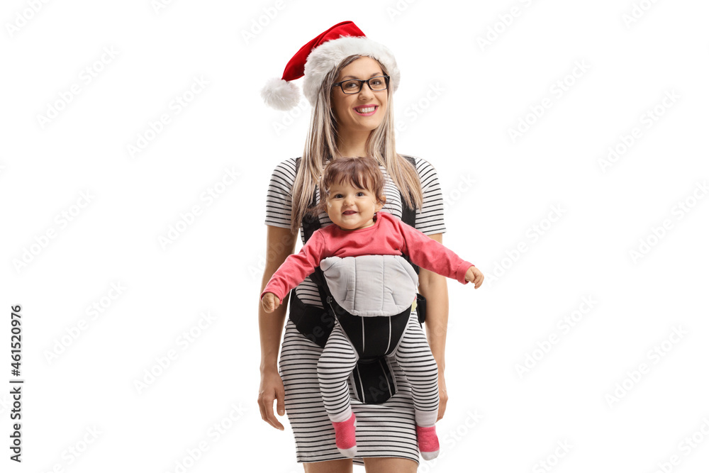 Smiling mother with a Santa Claus hat and a baby in a carrier Smiling mother with a Santa Claus hat and a baby in a carrier