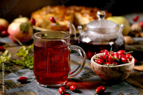 Rose hip berries herbal tea in glass teapot