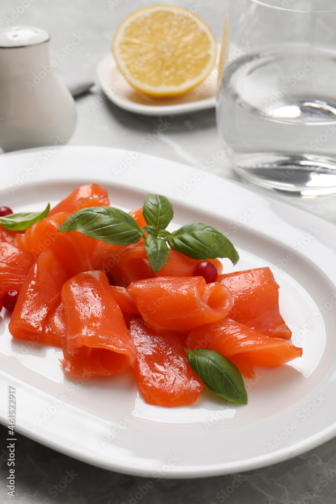 Salmon carpaccio with cranberries and basil served on table, closeup Salmon carpaccio with cranberries and basil served on table, closeup