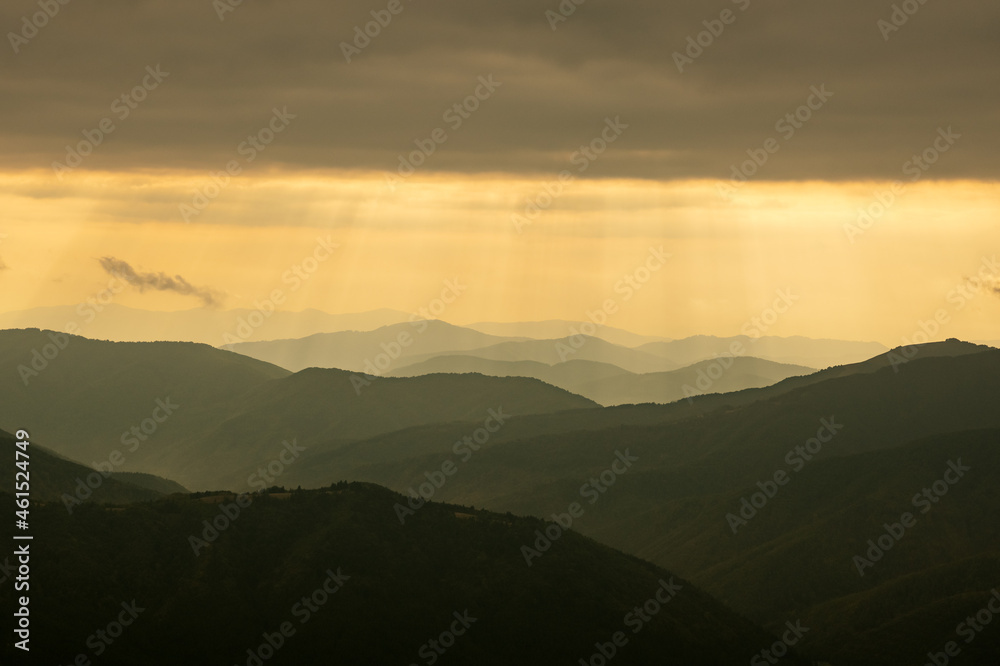 Morning sunlight in spring mountains. Beautiful sun rays on background. Landscape photography