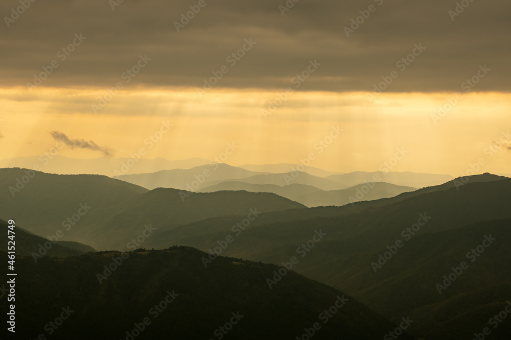 Obraz premium Morning sunlight in spring mountains. Beautiful sun rays on background. Landscape photography