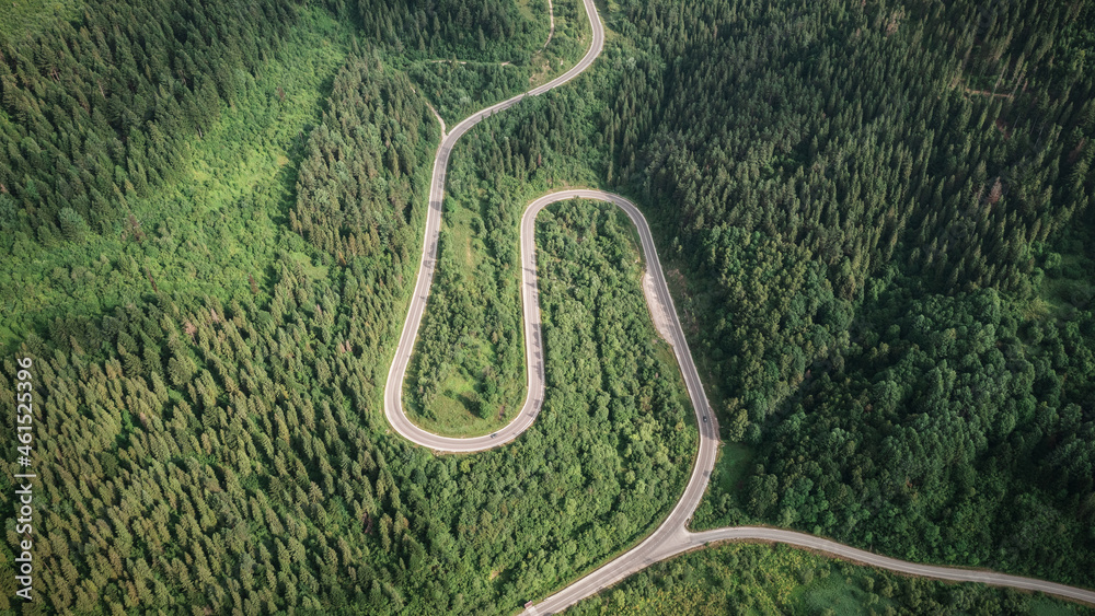 Flight over the summer mountains with mountain road serpentine, river and forest. Ukraine, Carpathian mountains. Landscape photography - obrazy, fototapety, plakaty 