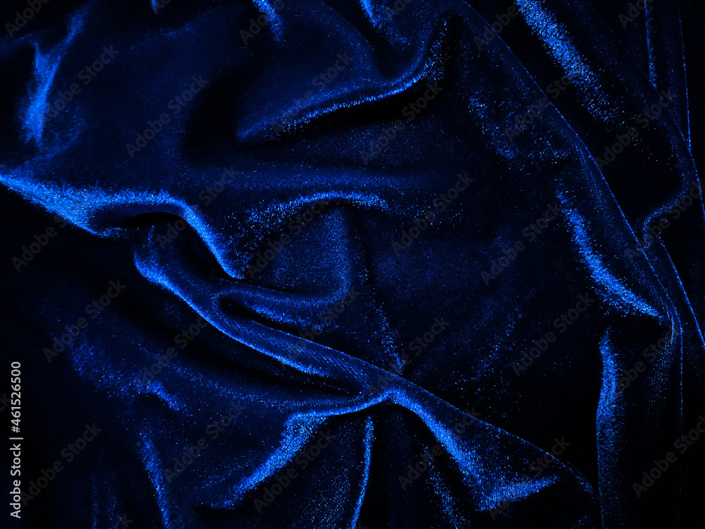 Blue velvet fabric texture used as background. Empty blue fabric