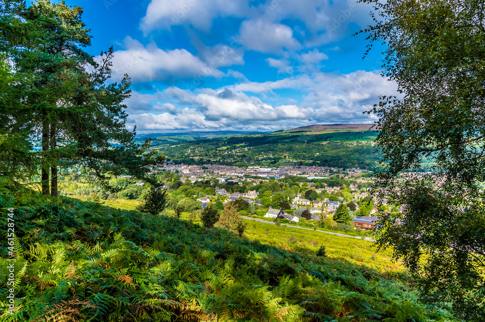 A tree framed view from Ilkley moor above the town of Ilkley Yorkshire, UK in summertime