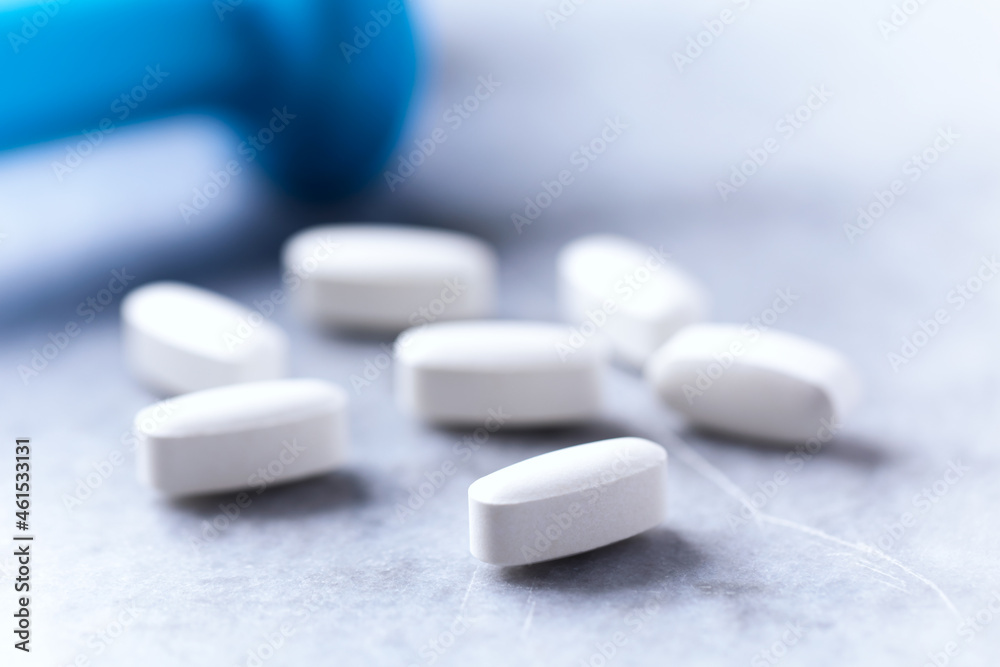 Lysine tablets. Concept for a healthy dietary supplementation. Nervous System Support. Bright stone background. Close up. Lysine tablets. Concept for a healthy dietary supplementation. Nervous System Support. Bright stone background. Close up.