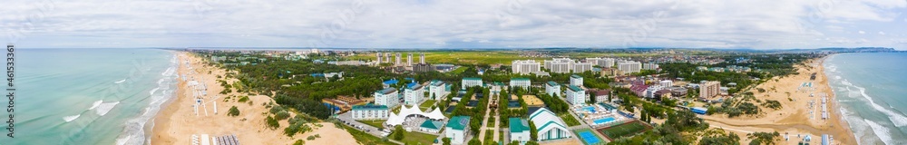 A picturesque panorama of the sea coast with a sandy beach in a resort near the city of Anapa and the village of Vityazevo.