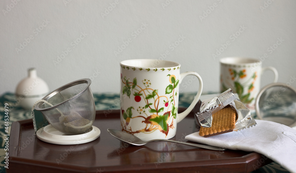 Cups of tea on a tray, with a cookie and a napkin Cups of tea on a tray, with a cookie and a napkin