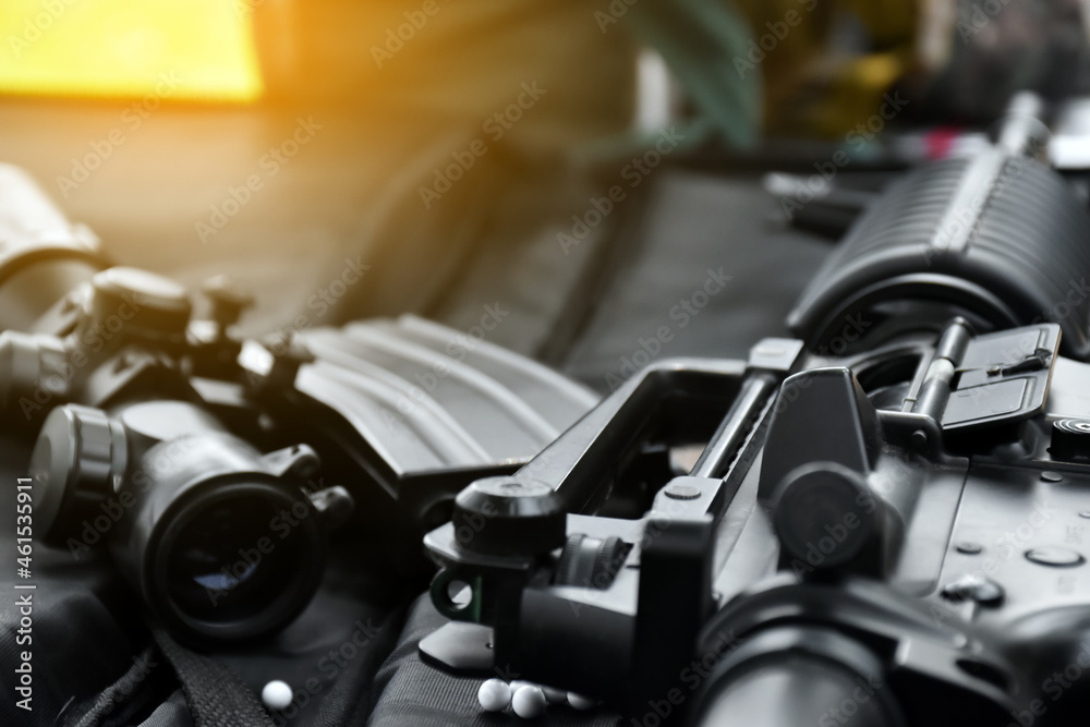 Fototapeta premium Airsoft or bbgun on black leather background. Selective and soft focus. concept for sport and recreations.