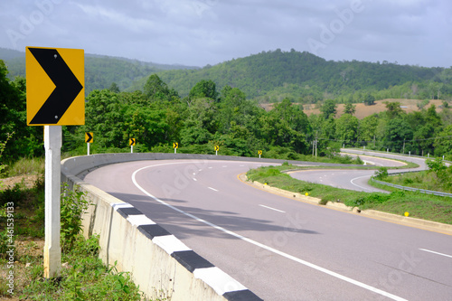 Driving safely on the road with warning signs on the way, dangerous curves, drive carefully on highways and country roads. photo