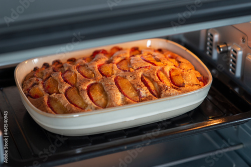 Step 6: Baking a pie in the oven. Step by step recipe for sweet plum pie. Sweet pastries on white background