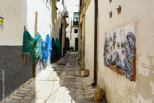 Drying fish nets in Mazara del Vallo narrow street on a summer day, Trapani, Sicily, Italy © Alessio Russo