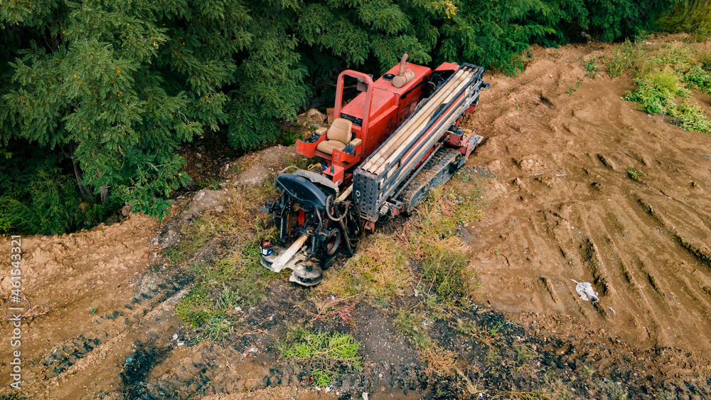 Horizontal directional drilling technology. Aerial view of Drilling machine work process. Trenchless laying of communications, pipes and water pipes