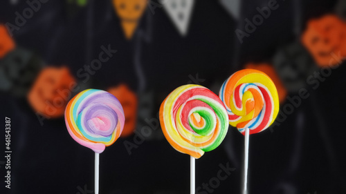 Colorful lollipops and halloween decoration in the background. Happy Halloween. Trick or treat.