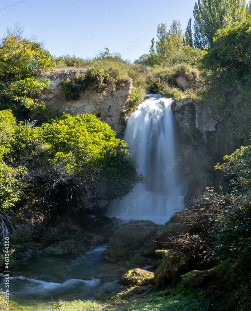 Beautiful autumn scene where a huge waterfall of water falls into the void of a canyon on a sunny autumn day, creating a relaxing atmosphere. Long exposure photography concept, autumn landscape. Beautiful autumn scene where a huge waterfall of water falls into the void of a canyon on a sunny autumn day, creating a relaxing atmosphere. Long exposure photography concept, autumn landscape.