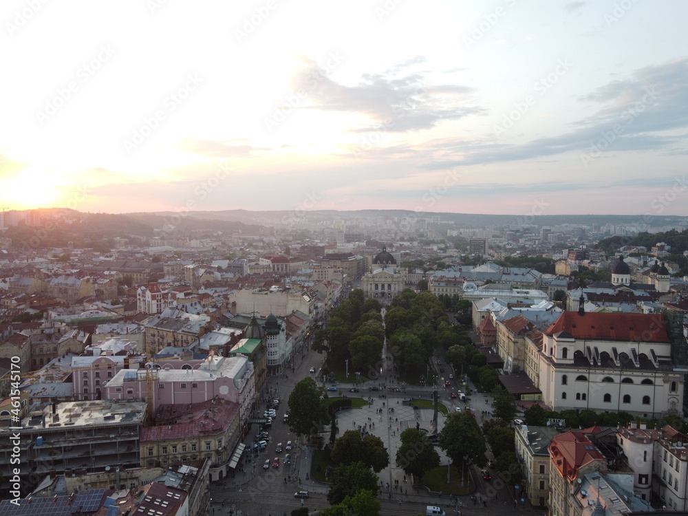 Very beautiful view from a height of the central square of the European city and a colorful sky at sunset.  Aerial photo of a very beautiful orange sky at sunset in the city.