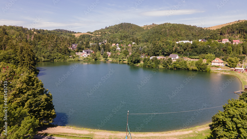 Fototapeta premium Aerial view of Vindsachtske lake in the village of Stiavnicke Bane in Slovakia