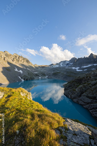 Fototapeta Naklejka Na Ścianę i Meble -  Wonderful scenery at an alpine lake called Wildsee in the canton of Saint Gallen. Epic sunset in the alps of Switzerland. Beautiful view with the tent in front and a perfect camping day.