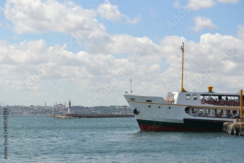 Ferryboat,ship at Kadikoy port in Istanbul, under cloudy blue sky on Bosphorus coast.