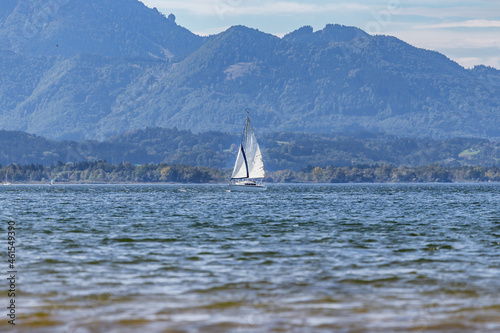 Beautiful landscape scenery with sailing boats in the water and mountains in the background at lake Chiemsee, bavaria