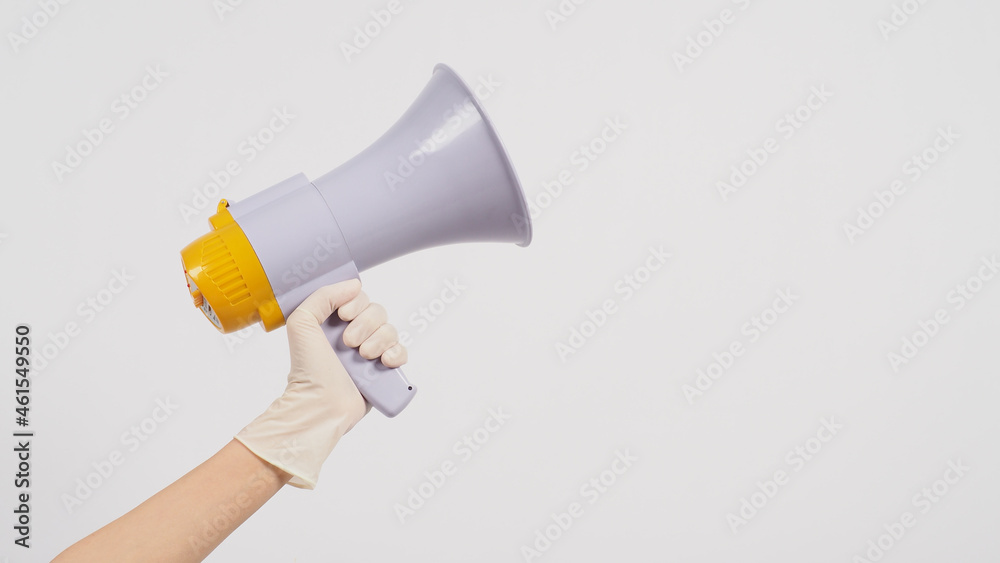 Hand is hold megaphone and wear medical glove on white background.. Hand is hold megaphone and wear medical glove on white background..