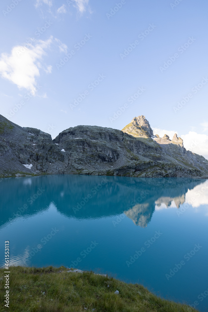 Wonderful view over a beautiful alpine lake in Switzerland called Schottensee. Epic sunrise over a perfect blue lake.