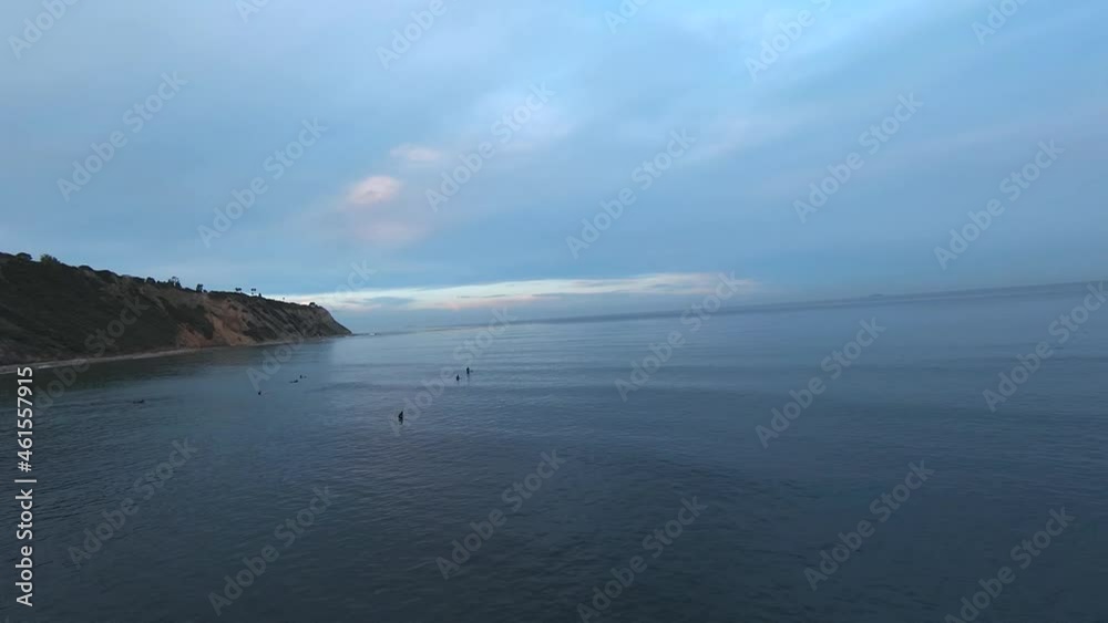 Surfers float in the ocean water near the bluff at Rancho Palos Verdes in Southern California - aerial view Surfers float in the ocean water near the bluff at Rancho Palos Verdes in Southern California - aerial view