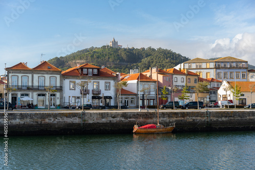 Viana do Castelo city viewed from the other side of the river with boats and Santa Luzia chruch sanctuary on the hill, in Portugal photo