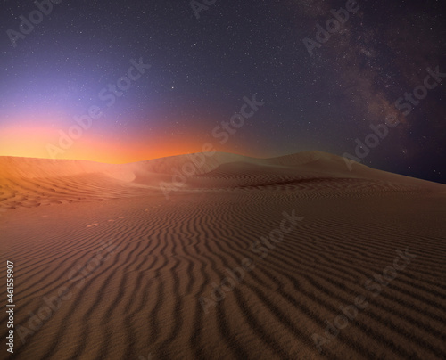 Scenic view of sandy desert under starry sky in night