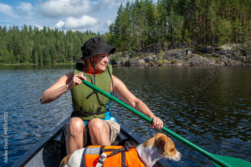 Woman canoeing at lake with dog