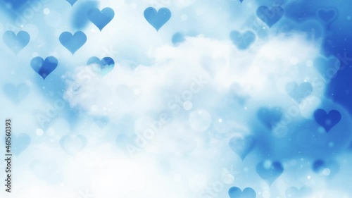 Blue blurry hearts on sky time lapse background with bokeh details. photo