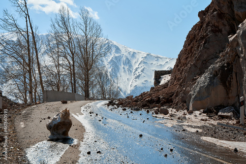 Early spring in the mountains. The rocks fell on the road. Dangerous bugle road. Rockfall in the mountains photo