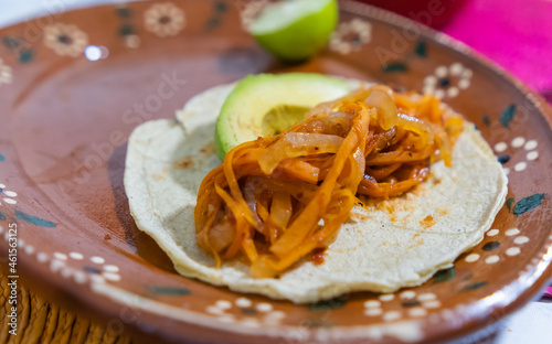 Vegan Mexican tinga taco on traditional clay plate photo
