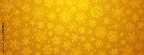 Christmas background of big and small complex snowflakes in yellow colors
